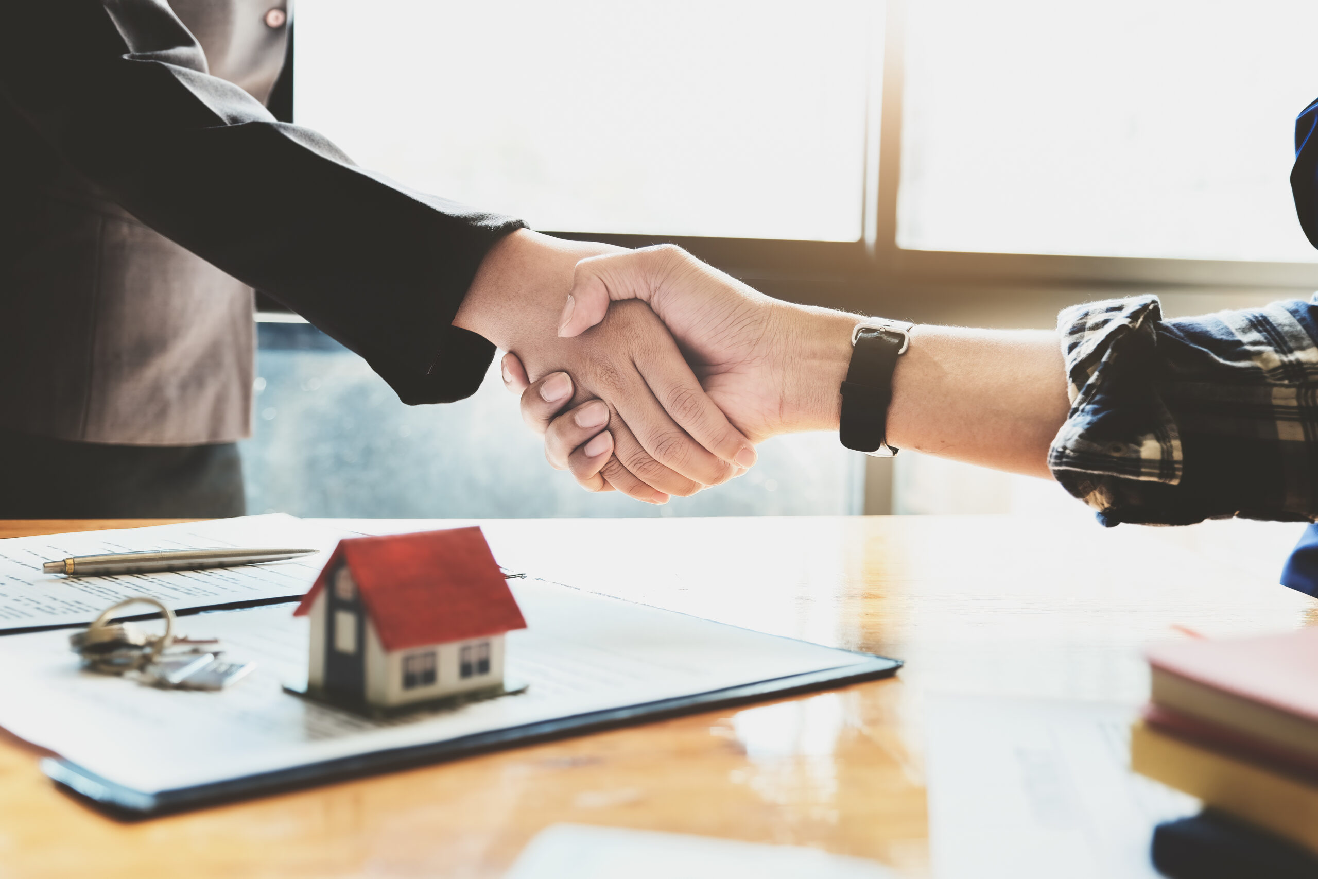 real estate agent and customer handshake